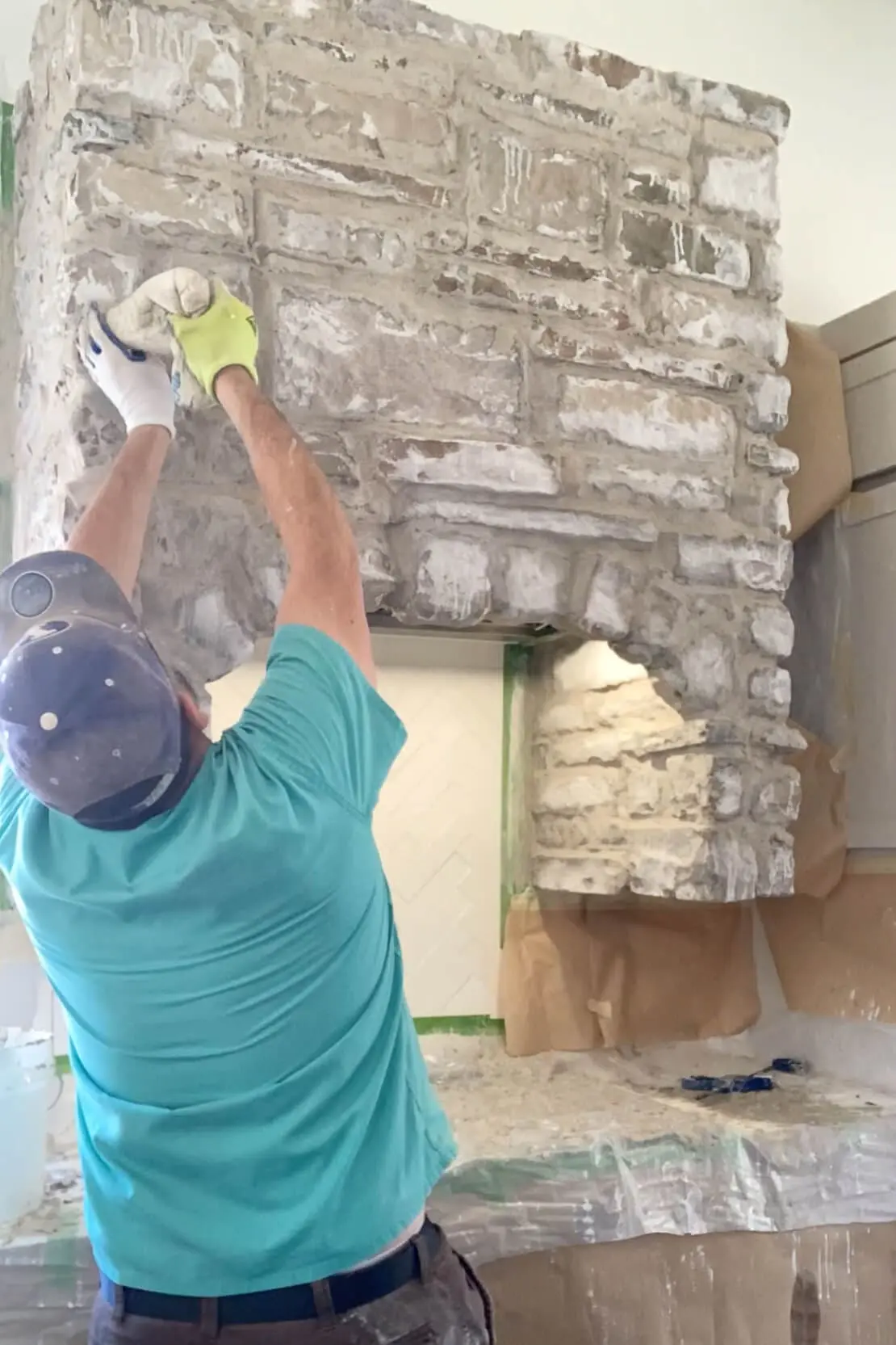 Using a mortar bag to finish a DIY stone range hood.